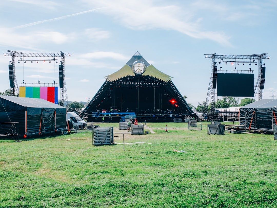 Scène de festival en plein air avec structures techniques et accès dégagés
